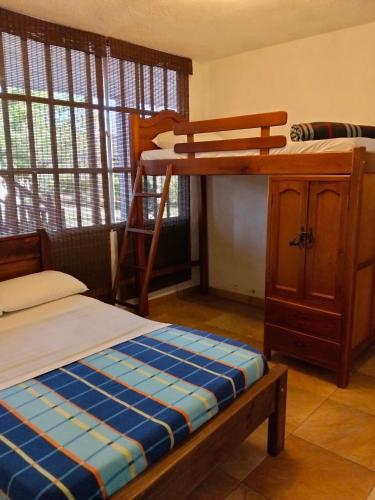 a bedroom with a bunk bed and a desk at Cabaña Barichara in Barichara