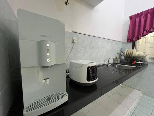 a coffee maker on a counter in a kitchen at Sweet Roses Homestay- Free WiFi, Nearby UiTM in Bandar Puncak Alam