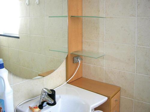 a bathroom with a sink and a mirror at Apartment in Cogoleto with pool in Cogoleto