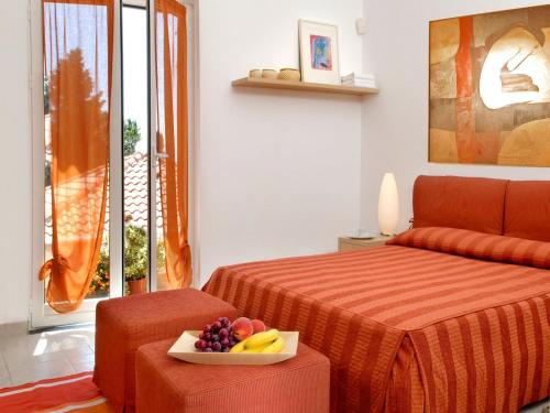 a bedroom with a bed and a bowl of fruit at Apartment in Cogoleto with pool in Cogoleto