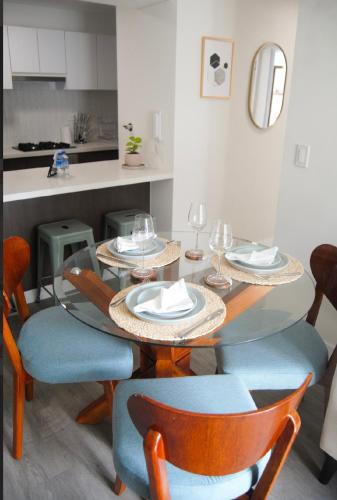 a dining room with a table and chairs with wine glasses at Warm & Exclusive 2 BR in San Antonio