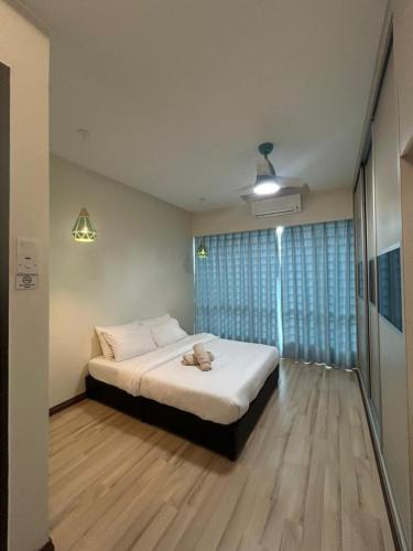 a bedroom with a bed and a ceiling fan at SDC Suite Home 6 in Lahad Datu