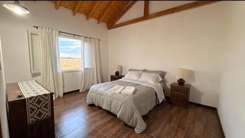 a bedroom with a large bed and a window at Quinta La Carlota in Navarro