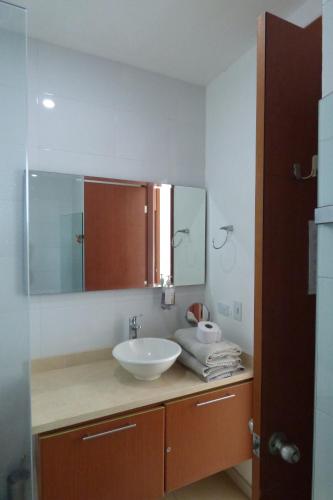 a bathroom with a sink and a mirror at Costa Azul Suites 401 in Santa Marta