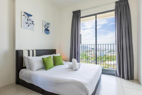 a bedroom with a large bed and a large window at Meritus Suites - 8pax in Perai