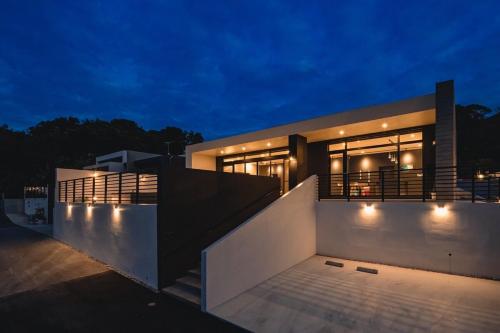 a house with lights on the side of it at night at Luxury Villa Maeda Unit2 in Onna