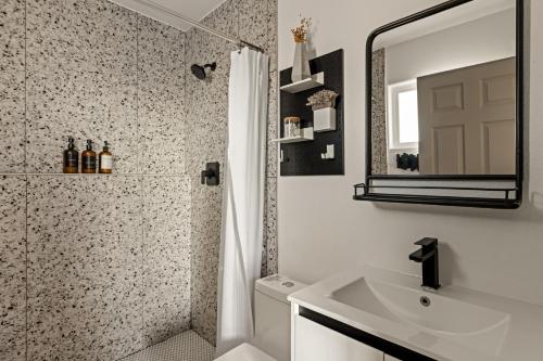 a bathroom with a shower and a sink and a mirror at Dark Star - Endless Stars, Cowboy Pool, Spa, Fire pit, BBQ in Twentynine Palms