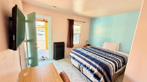 a bedroom with a bed and a table in it at El Rey Motel in Globe