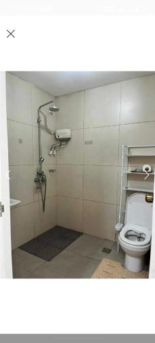a bathroom with a toilet and a shower stall at Condotel in Baguio City in Baguio
