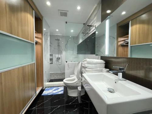 a bathroom with a sink and a toilet and a mirror at Viewtiful Elegant 16th Floor 1BR Getaway 1Euphoria in Angeles