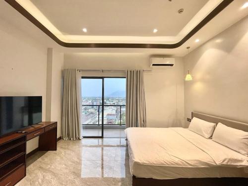 a bedroom with a bed and a large window at Viewtiful Elegant 16th Floor 1BR Getaway 1Euphoria in Angeles