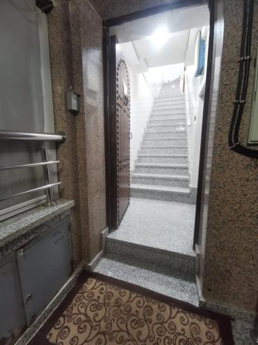 a door leading to a stairway with a gate and stairs at Hotel Restaurant Bougafer in Midelt