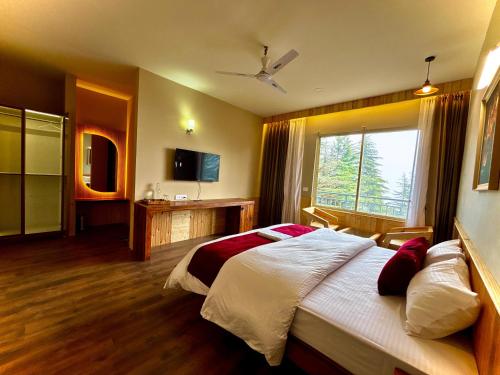 a bedroom with a large bed and a large window at Cedar wave in Munsyari