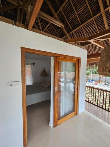 a room with a door leading to a bedroom at Pangaro House in Katiet