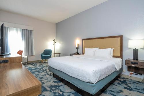 a hotel room with a bed and a television at Hampton Inn by Hilton Spring Hill in Timber Pines
