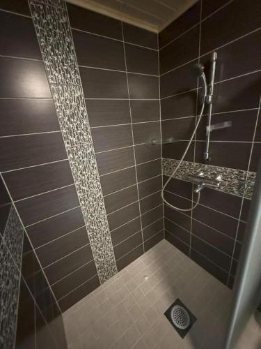 a bathroom with a shower with brown tile at Villa Maya, cottage for vacation holidays in Jaala