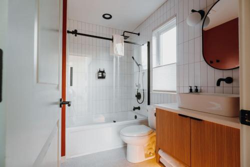 a bathroom with a tub and a toilet and a sink at Camp Alpine in Packwood