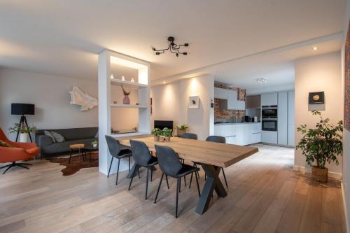a dining room and living room with a table and chairs at Unique tranquil spot with garden, centre Den Bosch in Den Bosch