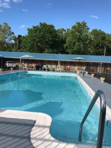 a large swimming pool in front of a building at Merrimac Inn and Suite in Williamsburg