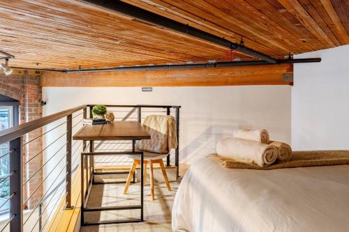 a guest bedroom with a bed and a desk at Massive Downtown Seattle Condo - Free Parking! in Seattle