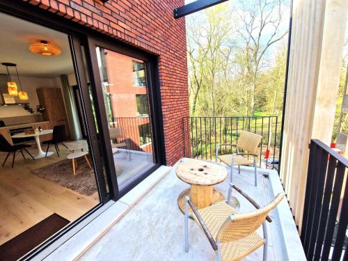 a patio with a table and chairs on a balcony at Waterloo Downtown Park in Waterloo