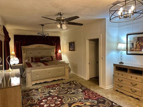 a bedroom with a bed and a ceiling fan at The Cleveland Cottage in Brookhaven