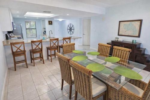 a dining room and kitchen with a table and chairs at Resort like super heated pool & direct beach front in South Padre Island