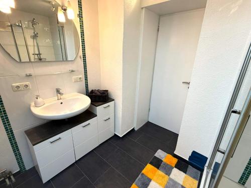 a bathroom with a sink and a mirror at Über den Dächern Kemptens mit Panoramablick in Kempten