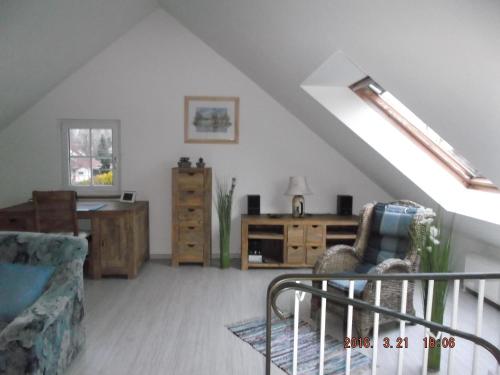 un soggiorno con divano, sedia e scrivania di Ferienhaushälfte Lütow a Lütow