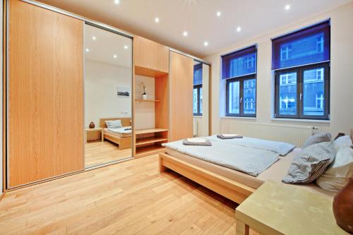 a bedroom with a bed and a large mirror at Family Apartments in Prague