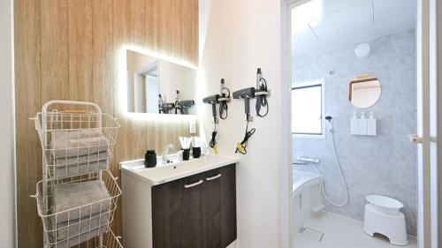 a bathroom with a sink and a toilet and a shower at LAZULI Fukutsu in Fukuoka