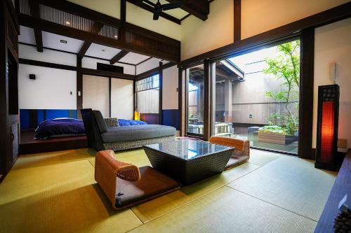 a living room with a couch and a table at Yunoyado Irifune in Aso
