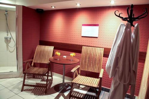 a dining room with two chairs and a table at Mercure Cieszyn in Cieszyn