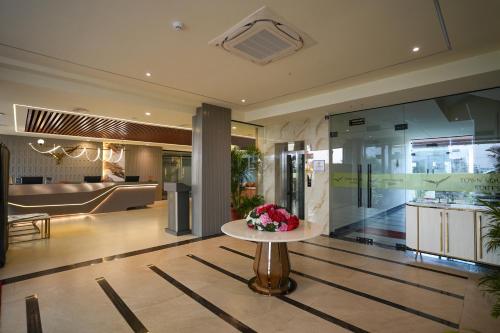 a lobby with a table with flowers on it at Town Square Suites in Hyderabad