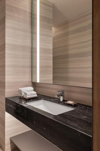 a bathroom with a sink and a mirror at Bengaluru Marriott Hotel Whitefield in Bangalore