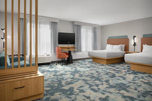 a hotel room with two beds and a flat screen tv at Hampton Inn & Suites Phoenix Chandler Fashion Center in Chandler