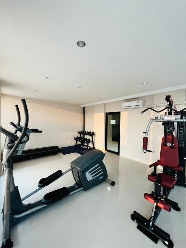 a gym with two treadmills and a treadmill at Prajan Residence in Buriram