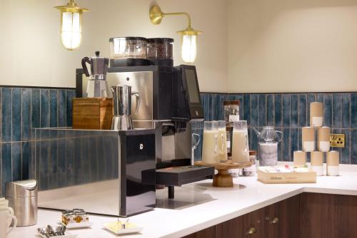 a coffee maker on a counter in a room at Hilton Edinburgh Carlton in Edinburgh
