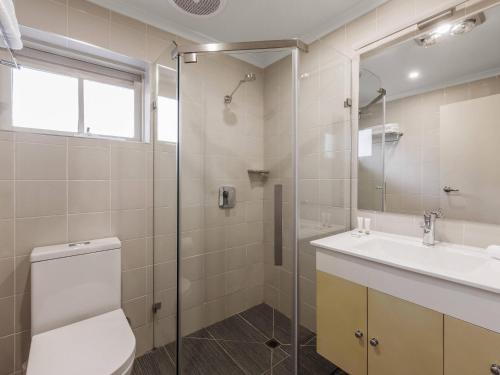 a bathroom with a toilet and a sink and a shower at Quality Hotel Melbourne Airport in Melbourne
