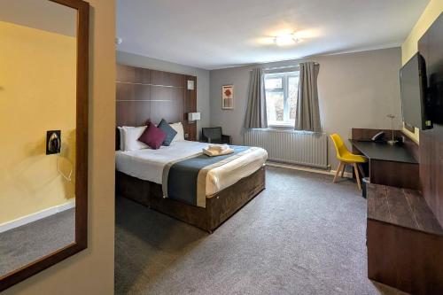 a hotel room with a bed and a desk at Quality Hotel Coventry in Coventry