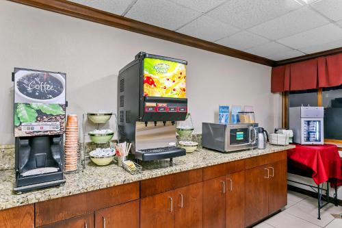 a kitchen with a counter with a television and food at Quality Inn Jessup - Columbia South Near Fort Meade in Jessup