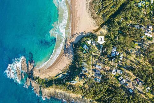 an aerial view of a beach and the ocean at Architectural Beachfront Escape Yowani House in Tomakin
