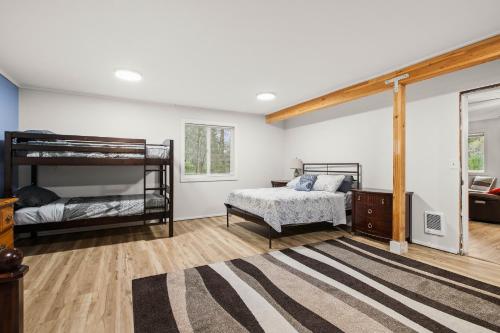 a bedroom with two bunk beds and a rug at 4-Bedroom Chateau in Southern Washington- Luxurious Retreat with Pond & Creek in Amboy