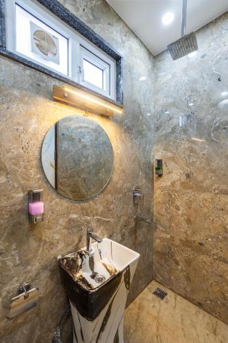 a bathroom with a sink and a mirror at Hotel The King Palace Free Pick up From Nizamuddin Railway Station in New Delhi