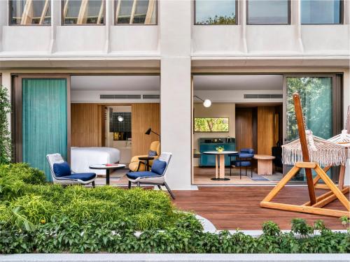 a patio with chairs and a table on a building at voco Bangkok Surawong by IHG in Bangkok