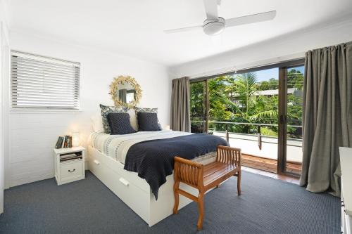 a bedroom with a bed and a large window at Noosa International Resort in Noosa Heads