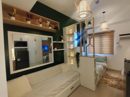 a living room with a couch and a window at Naomi's Green Haven in Dasmariñas