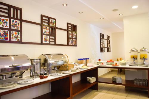 a buffet line with food on display in a restaurant at Hotel Gardenia Inn in San Salvador