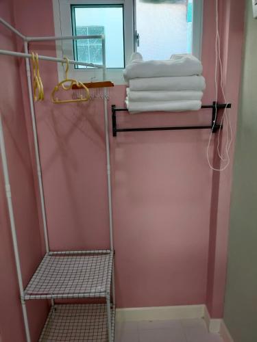 a towel rack in a bathroom with towels at Banyai Pool Villa Chiang Khan in Loei