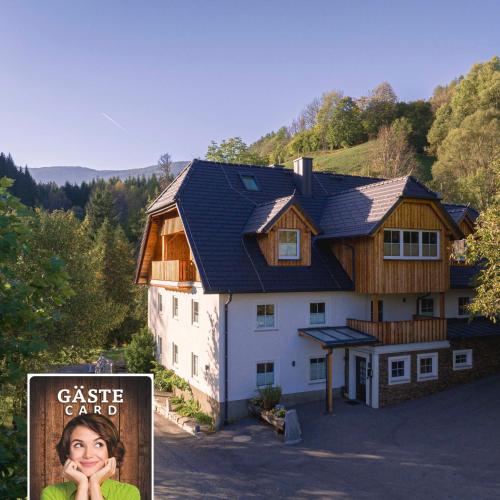 a house with a sign in front of it at Vitalhof am Kreischberg by ALPS RESORTS in Bodendorf